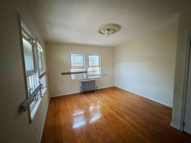 186-39 Ilion Ave, Saint Albans, NY 11412 - empty room featuring radiator heating unit, wood finished floors, and baseboards