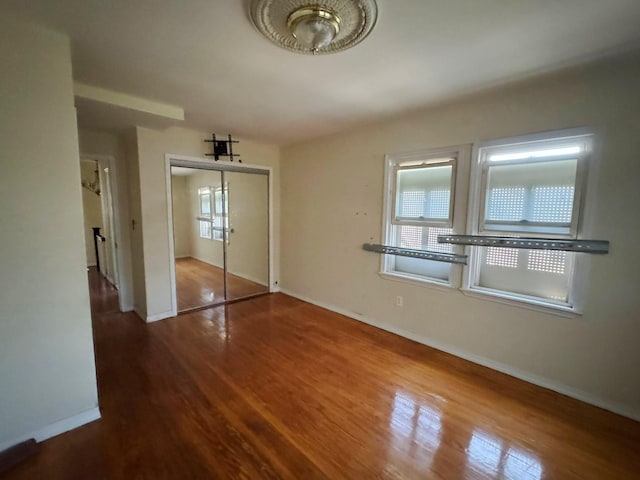 186-39 Ilion Ave, Saint Albans, NY 11412 - unfurnished bedroom with wood finished floors, baseboards, and a closet