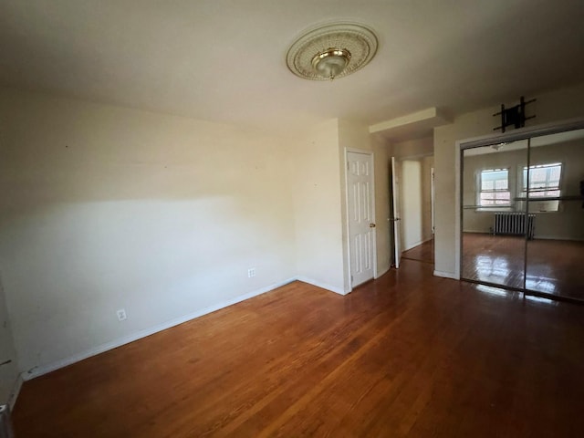 186-39 Ilion Ave, Saint Albans, NY 11412 - unfurnished dining area with radiator, wood finished floors, and baseboards