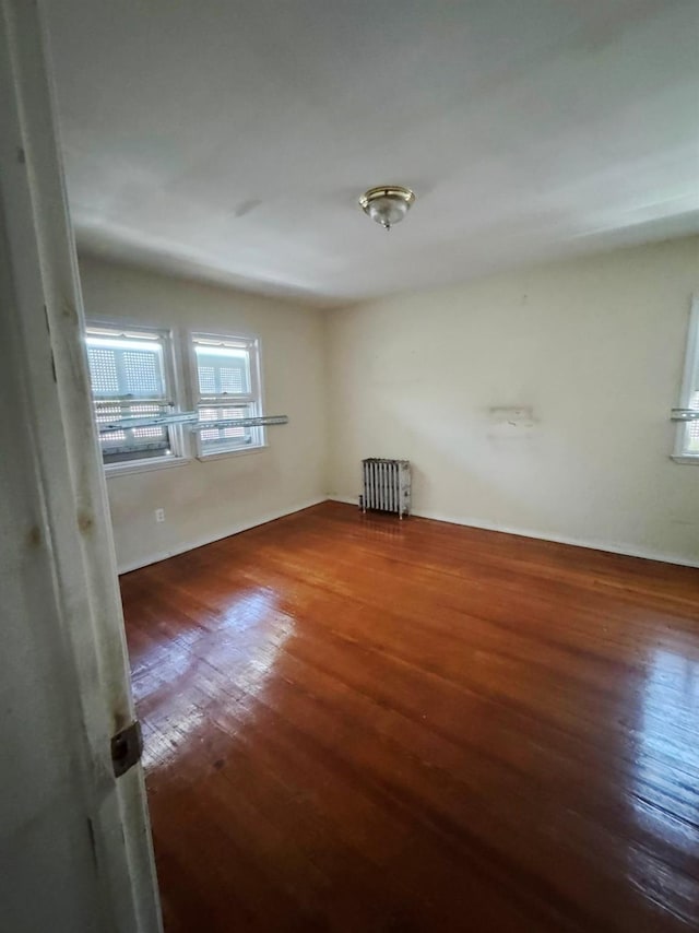 186-39 Ilion Ave, Saint Albans, NY 11412 - unfurnished room with wood finished floors, radiator heating unit, and baseboards