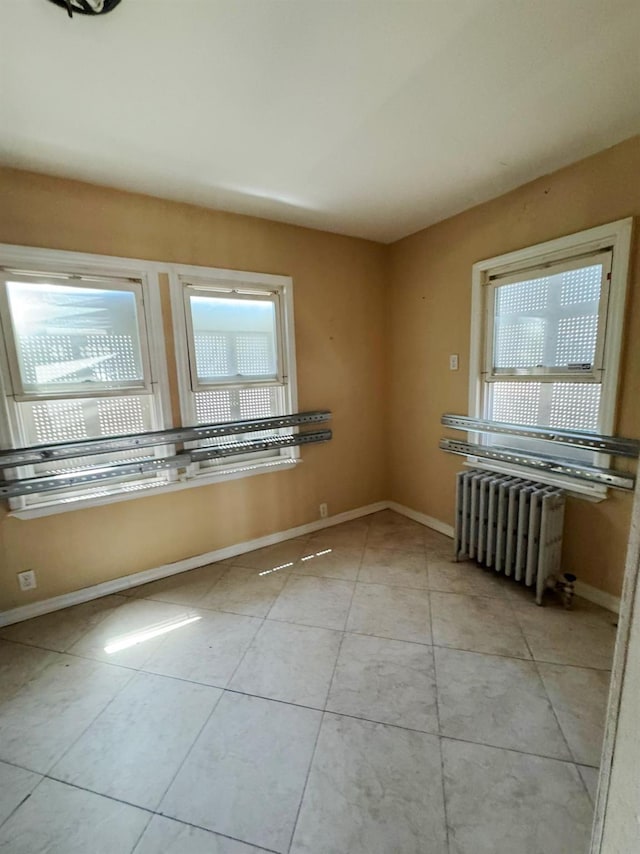 186-39 Ilion Ave, Saint Albans, NY 11412 - tiled spare room with radiator heating unit and baseboards