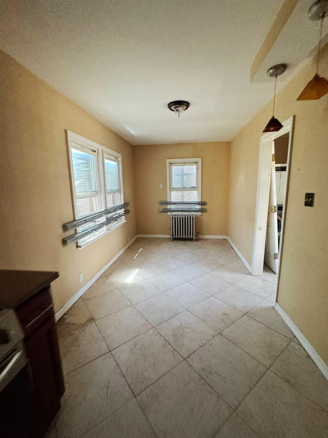 186-39 Ilion Ave, Saint Albans, NY 11412 - unfurnished room featuring radiator heating unit, baseboards, and light tile patterned floors