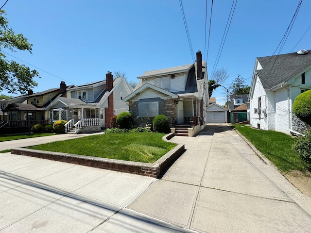 186-39 Ilion Ave, Saint Albans, NY 11412 - view of front facade featuring a residential view, concrete driveway, a garage, and a front lawn