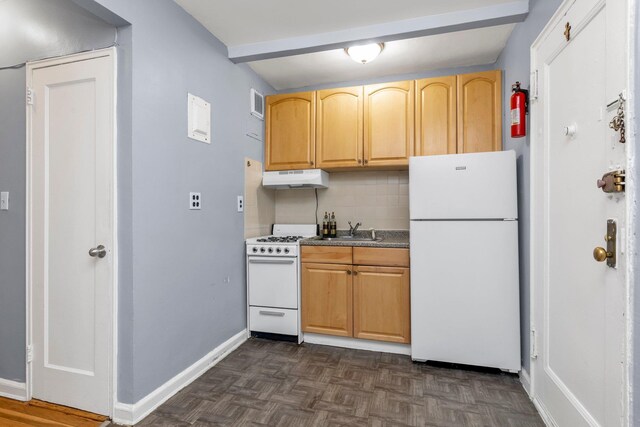84-19 51st Ave Unit 2E, Elmhurst, NY 11373 - kitchen featuring white appliances, under cabinet range hood, a sink, decorative backsplash, and baseboards