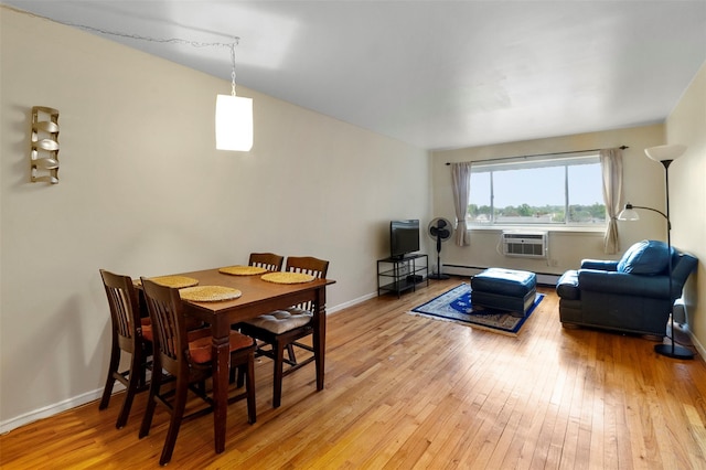 395 Westchester Ave Unit 3A, Port Chester, NY 10573 - dining room with light wood-style floors, a wall mounted AC, and baseboard heating