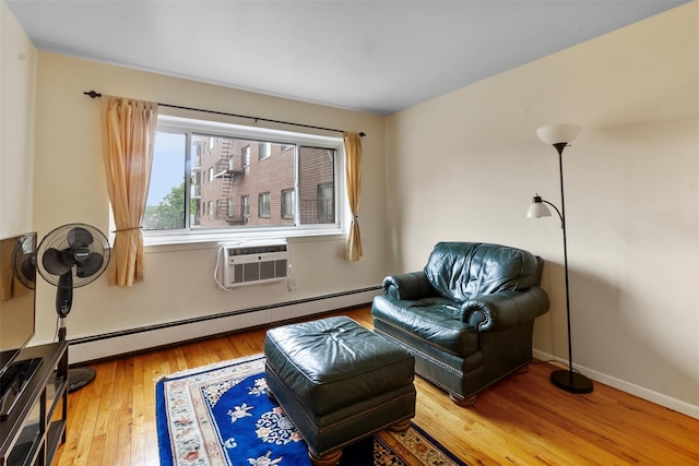 395 Westchester Ave Unit 3A, Port Chester, NY 10573 - sitting room featuring a baseboard radiator, a wall mounted air conditioner, and wood finished floors