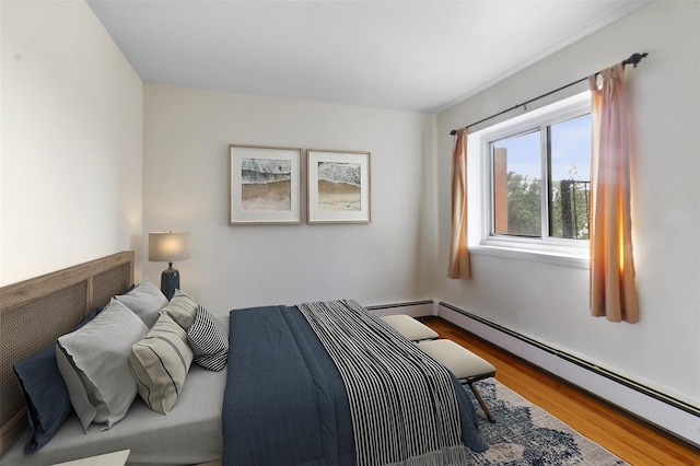 395 Westchester Ave Unit 3A, Port Chester, NY 10573 - bedroom with a baseboard heating unit and wood finished floors