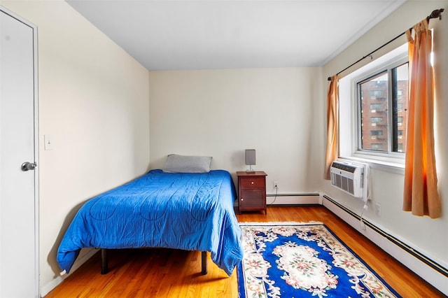 395 Westchester Ave Unit 3A, Port Chester, NY 10573 - bedroom with wood finished floors, a baseboard radiator, and cooling unit