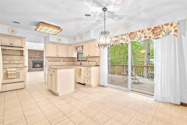 123 Birch Ln, New City, NY 10956 - kitchen with white appliances, cream cabinetry, decorative backsplash, and a chandelier