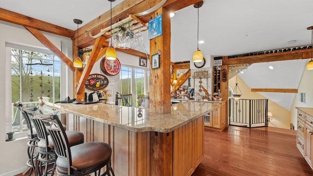 42 Blackstone Rdg, Holmes, NY 12531 - kitchen with wood finished floors, a kitchen breakfast bar, light stone counters, decorative light fixtures, and recessed lighting