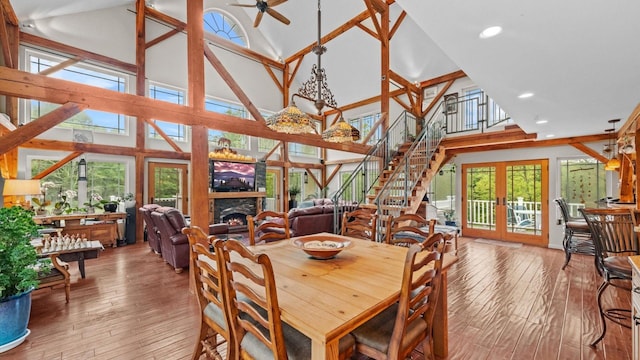 42 Blackstone Rdg, Holmes, NY 12531 - dining space with high vaulted ceiling, french doors, a ceiling fan, stairs, and a lit fireplace