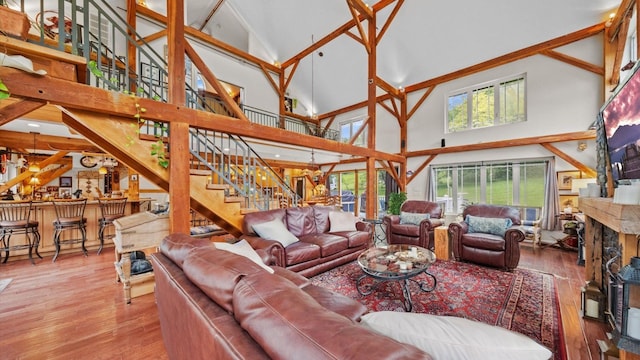 42 Blackstone Rdg, Holmes, NY 12531 - living room with high vaulted ceiling, hardwood / wood-style flooring, stairway, bar area, and a premium fireplace