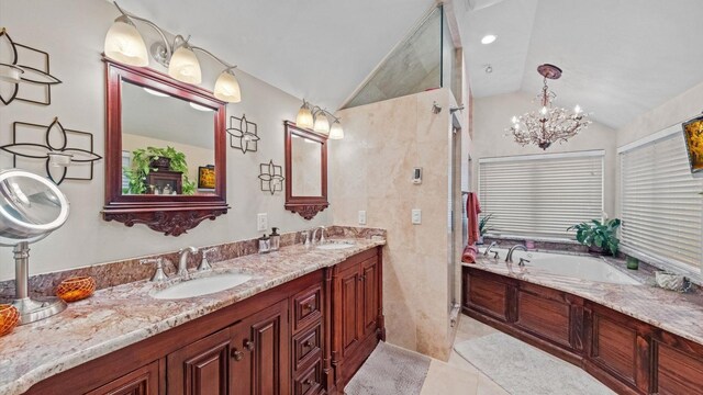 42 Blackstone Rdg, Holmes, NY 12531 - bathroom featuring lofted ceiling, a bath, double vanity, tile patterned flooring, and a chandelier