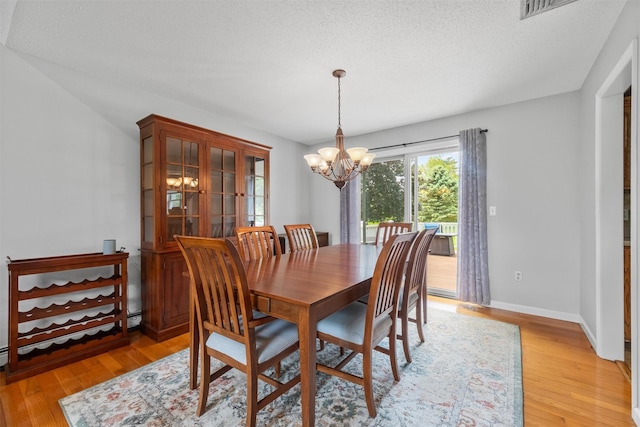 7 Brandy Ln, Hopewell Junction, NY 12590 - dining room featuring a chandelier, light wood-type flooring, a textured ceiling, and baseboards