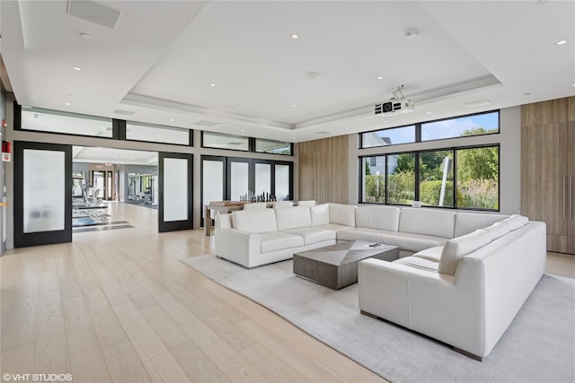 18 Rose Ln, Rye Brook, NY 10573 - living area featuring a raised ceiling, light wood-style flooring, recessed lighting, and floor to ceiling windows