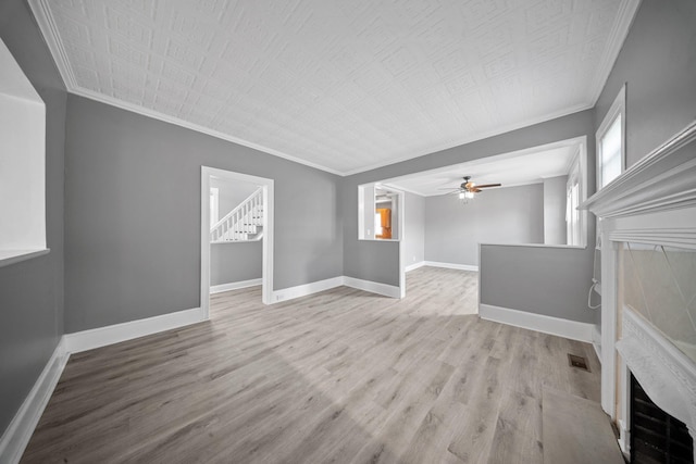 199 Central Ave, Bethpage, NY 11714 - unfurnished living room featuring a tiled fireplace, ornamental molding, wood finished floors, baseboards, and ceiling fan