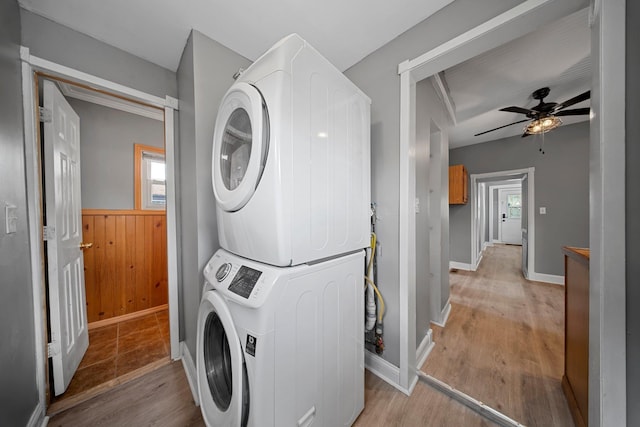 199 Central Ave, Bethpage, NY 11714 - laundry room featuring stacked washing machine and dryer, plenty of natural light, light wood-style floors, and a wainscoted wall