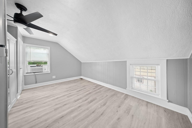 199 Central Ave, Bethpage, NY 11714 - bonus room featuring a textured ceiling, light wood-style flooring, baseboards, lofted ceiling, and a ceiling fan