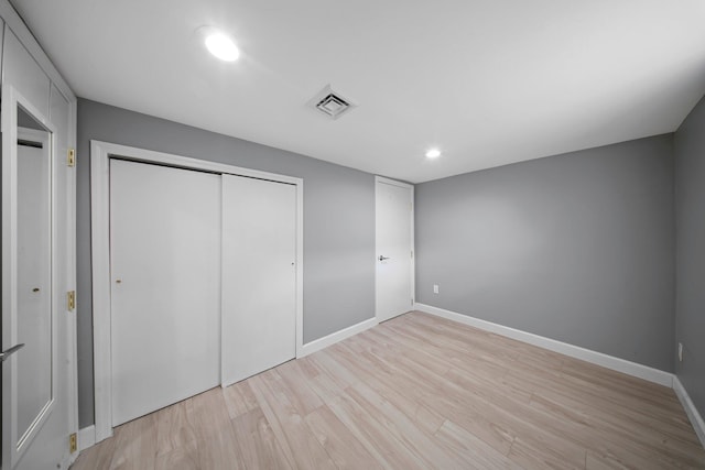 199 Central Ave, Bethpage, NY 11714 - unfurnished bedroom with light wood-style flooring, recessed lighting, a closet, and baseboards
