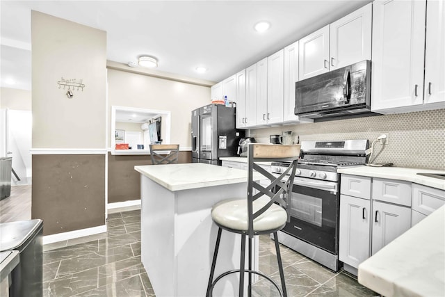 187-16 Williamson Ave, Springfield Gardens, NY 11413 - kitchen with black microwave, stainless steel gas range, fridge with ice dispenser, marble finish floors, and backsplash