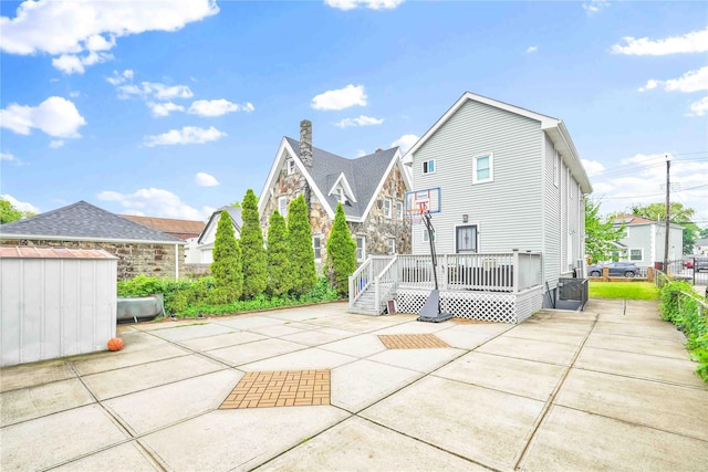 187-16 Williamson Ave, Springfield Gardens, NY 11413 - back of property featuring a patio, a deck, fence, a storage shed, and stone siding