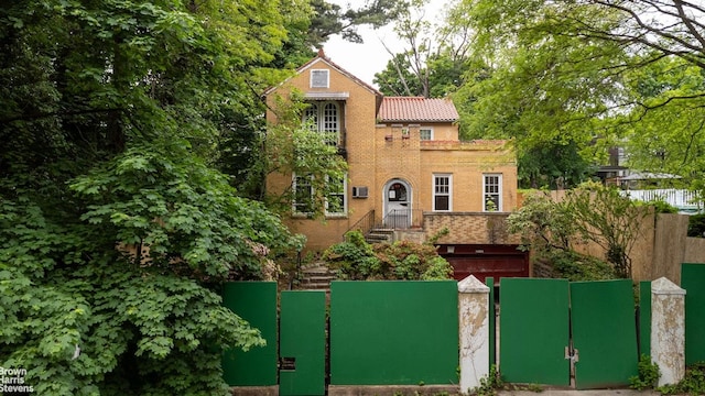 3115 Netherland Ave, Bronx, NY 10463 - view of front of property featuring a gate, a tile roof, and brick siding