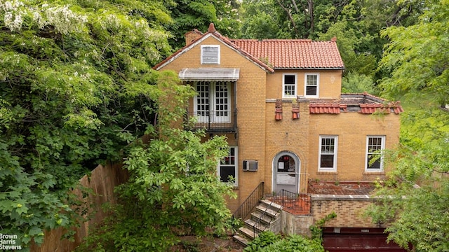 3115 Netherland Ave, Bronx, NY 10463 - view of front facade featuring a tile roof, a chimney, brick siding, and entry steps