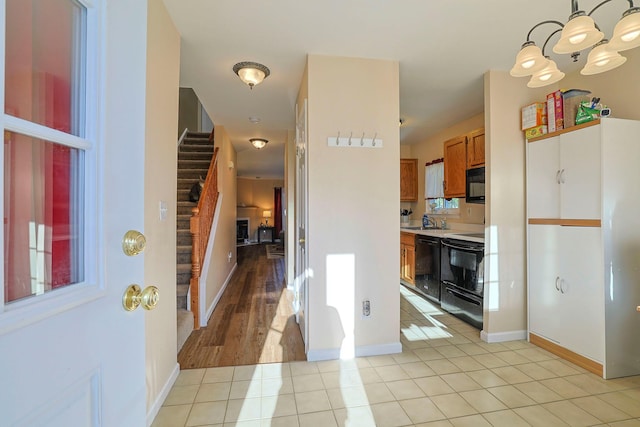 601 Covington Green Ln, Patterson, NY 12563 - foyer entrance with a chandelier, light tile patterned floors, and stairway