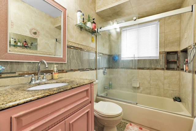 23 Berkeley Ave, Selden, NY 11784 - full bathroom with toilet, vanity, enclosed tub / shower combo, tile walls, and tasteful backsplash