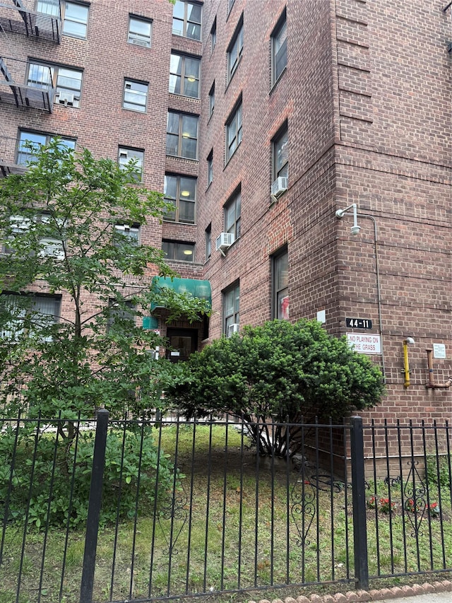 44-11 Macnish St Unit 1E, Elmhurst, NY 11373 - view of apartment building / complex featuring fence and cooling unit