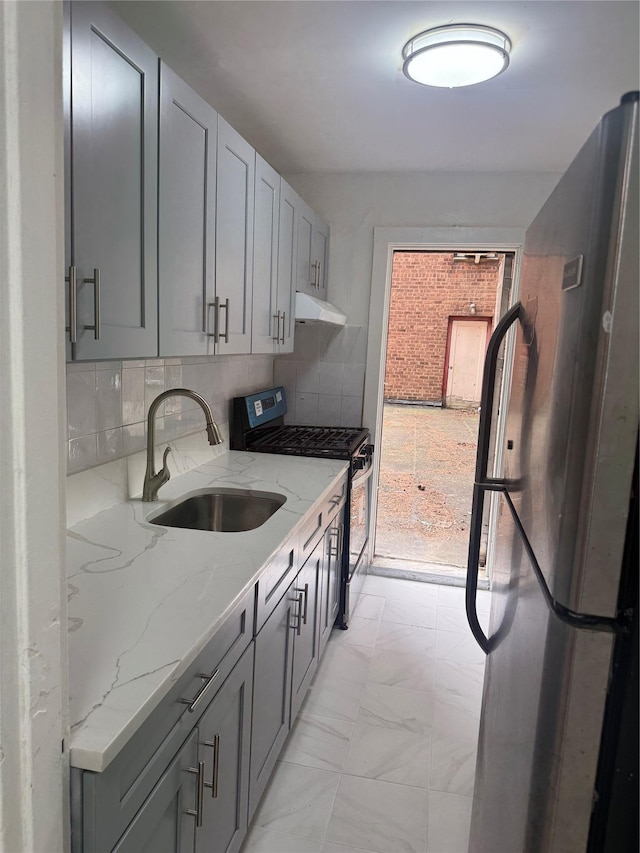 44-11 Macnish St Unit 1E, Elmhurst, NY 11373 - kitchen featuring appliances with stainless steel finishes, a sink, under cabinet range hood, and light stone countertops
