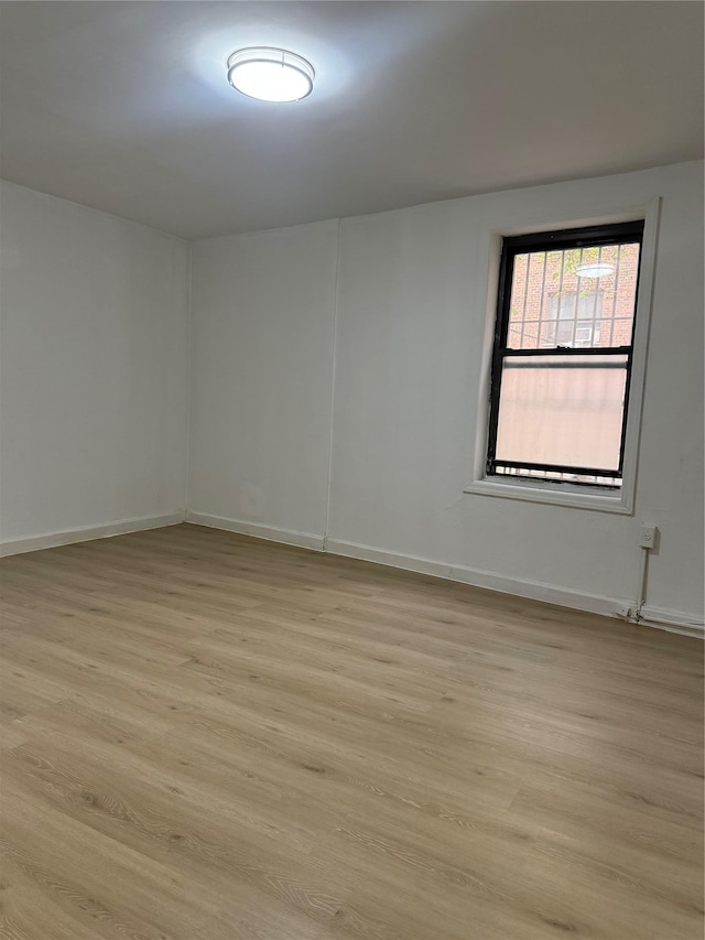 44-11 Macnish St Unit 1E, Elmhurst, NY 11373 - spare room with light wood-style flooring and baseboards