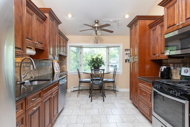 449 Terry Blvd, Holbrook, NY 11741 - kitchen with appliances with stainless steel finishes, a sink, a ceiling fan, decorative backsplash, and dark stone countertops