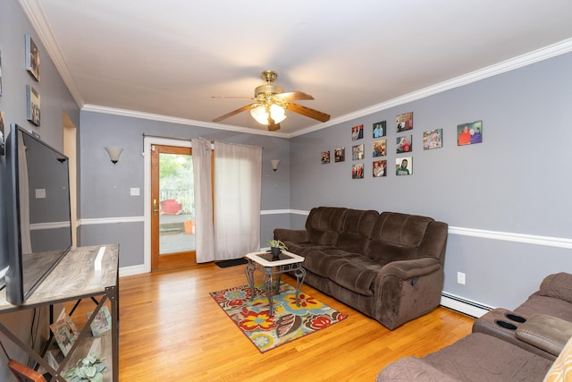 449 Terry Blvd, Holbrook, NY 11741 - living area with baseboard heating, wood finished floors, crown molding, ceiling fan, and baseboards
