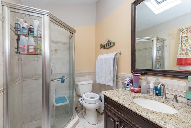 449 Terry Blvd, Holbrook, NY 11741 - bathroom featuring a skylight, toilet, tile patterned floors, vanity, and tile walls