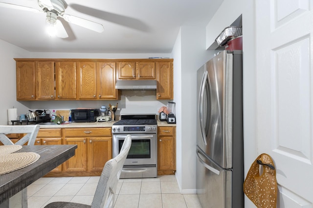 449 Terry Blvd, Holbrook, NY 11741 - kitchen with stainless steel appliances, under cabinet range hood, light countertops, brown cabinetry, and a ceiling fan