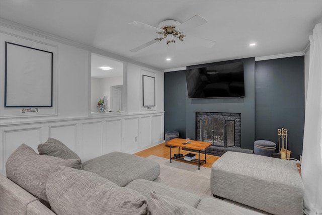 5 Michelle Ln, Selden, NY 11784 - living area with a fireplace with raised hearth, light wood-type flooring, ornamental molding, recessed lighting, and a ceiling fan