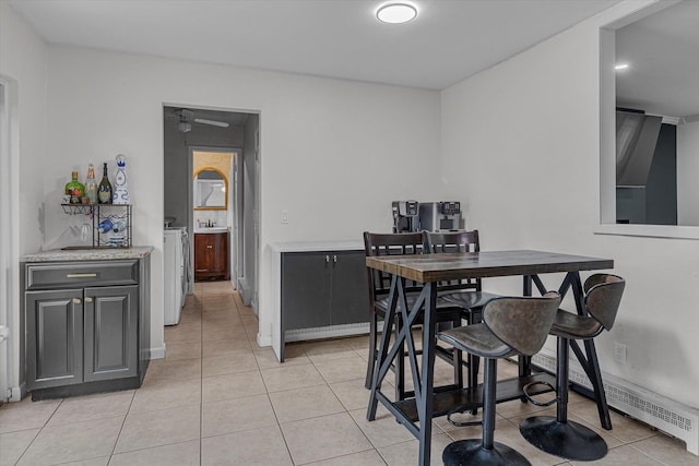 5 Michelle Ln, Selden, NY 11784 - dining space with light tile patterned flooring, a ceiling fan, and separate washer and dryer