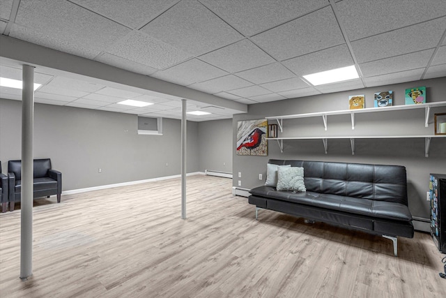 5 Michelle Ln, Selden, NY 11784 - finished basement featuring a baseboard heating unit, a paneled ceiling, and wood finished floors