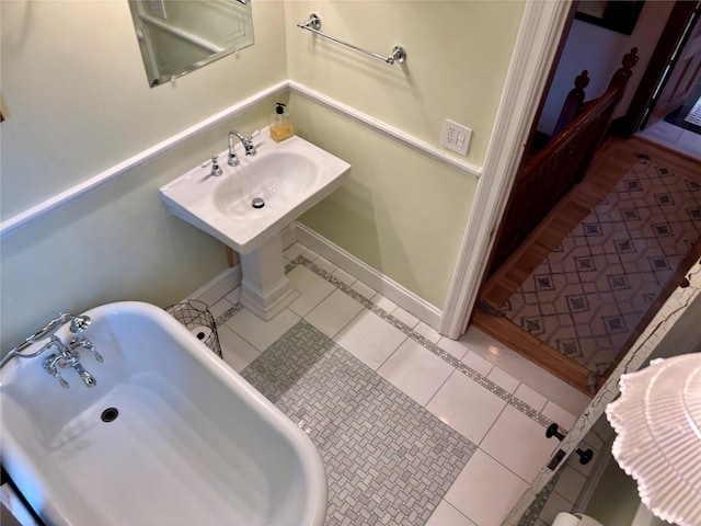 2 Lincoln Ter, Newburgh, NY 12550 - bathroom featuring a freestanding tub, tile patterned flooring, and a sink