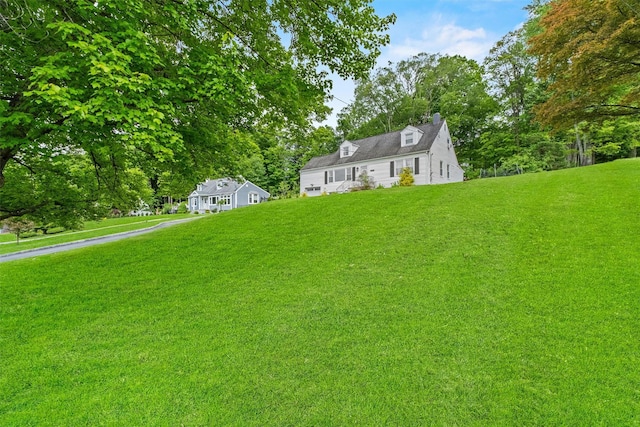 3518 Overlook Ave, Yorktown Heights, NY 10598 - view of front of home featuring a front lawn, a chimney, and view of scattered trees