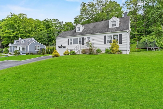 3518 Overlook Ave, Yorktown Heights, NY 10598 - cape cod home featuring a trampoline, asphalt driveway, a garage, a chimney, and a front yard