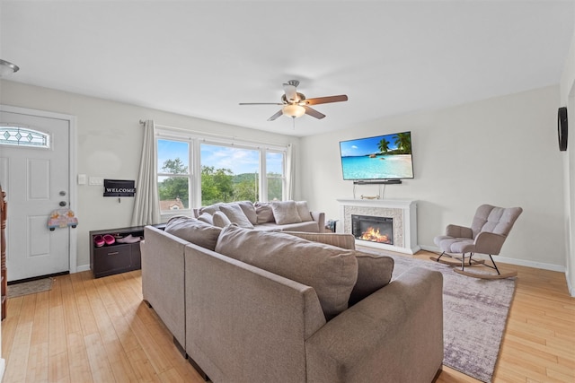 3518 Overlook Ave, Yorktown Heights, NY 10598 - living room with ceiling fan, a glass covered fireplace, light wood finished floors, and baseboards