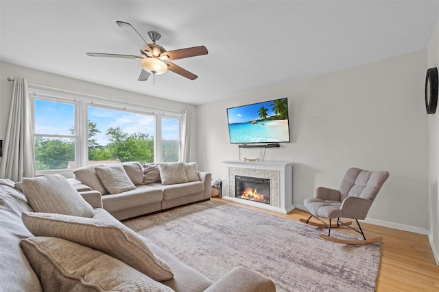 3518 Overlook Ave, Yorktown Heights, NY 10598 - living area with a ceiling fan, light wood-style floors, a glass covered fireplace, and baseboards