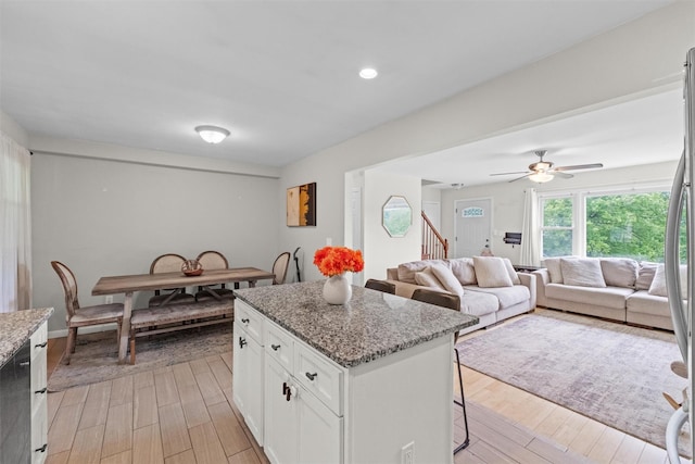 3518 Overlook Ave, Yorktown Heights, NY 10598 - kitchen featuring a center island, light stone counters, a breakfast bar, white cabinets, and recessed lighting