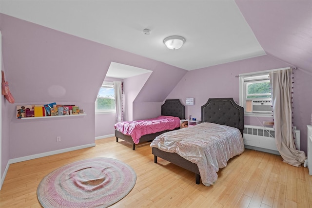 3518 Overlook Ave, Yorktown Heights, NY 10598 - bedroom featuring vaulted ceiling, wood finished floors, cooling unit, baseboards, and radiator heating unit