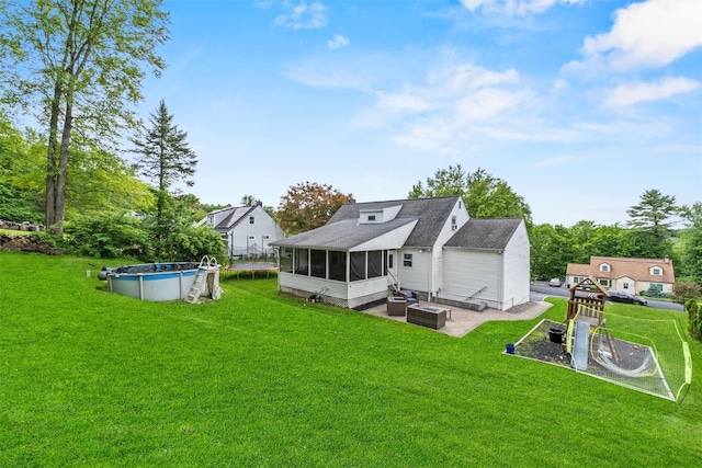 3518 Overlook Ave, Yorktown Heights, NY 10598 - rear view of house with a sunroom, a yard, and a trampoline