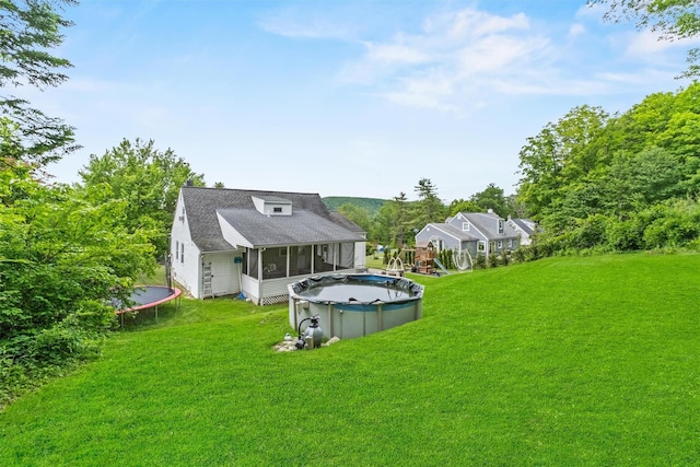 3518 Overlook Ave, Yorktown Heights, NY 10598 - back of property featuring a trampoline, a sunroom, a covered pool, and a yard
