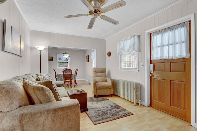 5 The Promenade, Glen Head, NY 11545 - living room featuring radiator, light wood-type flooring, ornamental molding, ceiling fan, and baseboards