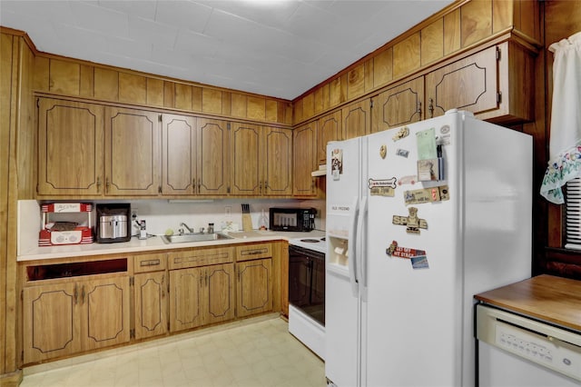 5 The Promenade, Glen Head, NY 11545 - kitchen featuring white appliances, a sink, brown cabinets, light floors, and light countertops
